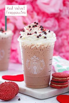 red velvet frappuccino drink with whipped cream and chocolate cookies on the side