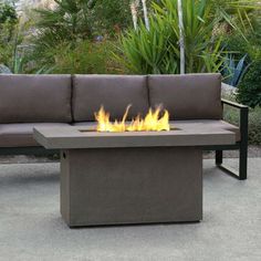 a fire pit sitting on top of a cement bench