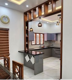 an open kitchen and dining room area with wood accents on the walls, tile flooring and wooden cabinets