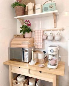 a small kitchen with white walls and wooden shelves