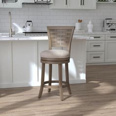 a kitchen scene with focus on the bar stool