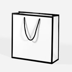 a black and white shopping bag with a rope on the handle that is attached to it