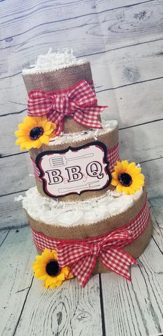 three tiered cake decorated with sunflowers and burlocks on the side