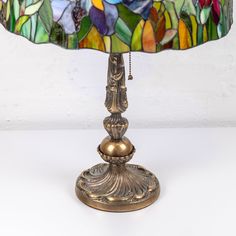 a stained glass lamp sitting on top of a table