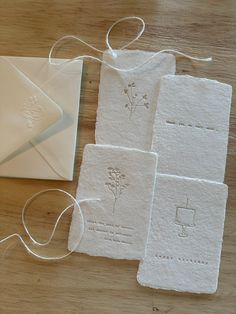 some white cards and string on a wooden table