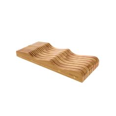 a wooden cutting board with wavy lines on the top and bottom, against a white background