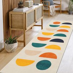 an area rug with circles on it in a living room next to a table and chair