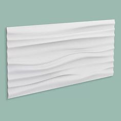 a piece of white paper with wavy lines on the top and bottom, against a green background