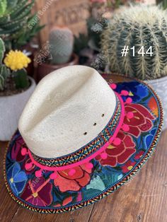 This beautiful Mexican Fedora is made out of Palm and has beautiful embroidered flowers. It is perfect to add that special touch to any outfit. The hat itself is made out of Palm and is very light and breathable. Find more colors here: https://www.etsy.com/es/listing/1004902053/sombrero-mexicano-de-palma-sombrero?ref=listing_published_alert Multicolor Panama Hat For Spring Festival, Wide Brim Straw Hat For Cinco De Mayo Festival, Multicolor Wide Brim Panama Hat For Festivals, Embroidered Short Brim Beach Hat, Multicolor Bohemian Fedora Panama Hat, Traditional Wide Brim Hat For Cinco De Mayo, Bohemian Multicolor Fedora Panama Hat, Traditional Curved Brim Hat For Cinco De Mayo, Traditional Hat For Cinco De Mayo Festival