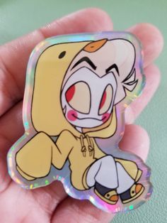 a person holding a small sticker with a cartoon character on it's back