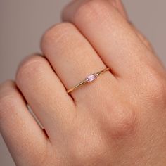 A simple stacking ring with a baguette pink sapphire gemstone in 14K solid gold. A dainty ring for women, ideal for stacking with more dainty rings. The best Christmas gift for girlfriend.  100% handcrafted with love! PRODUCT DETAILS * Material: 14K solid white gold, 14K solid gold * Gemstone: Pink Sapphire, natural gemstone * Sapphire's Weight: 0.12 ct * Sapphire's Dimensions 4mm x 2mm HOW TO ORDER - CUSTOM ORDERS * Choose from the drop down menus the available options (Ring size, Metal) and leave us a note for any special requirements. * For special orders (if you wish the ring to match an existing engagement ring) forward us pictures of the ring on a ruler from the front, side and top to mark the measurements, so we can adjust the design to fit properly to your engagement ring. PRODUCTI Dainty Gemstone Ring, Sapphire Baguette Ring, Anniversary Gift For Girlfriend, Best Anniversary Gifts, Dainty Rings, Baguette Ring, Gem Diamonds, Christmas Gifts For Girlfriend, Pink Sapphire Ring