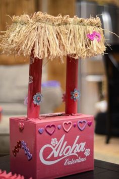 a coca - cola carton decorated with flowers and hearts, sitting on a table