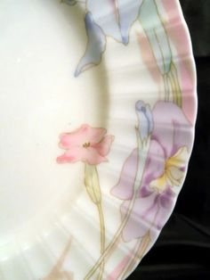 a white plate with flowers painted on it