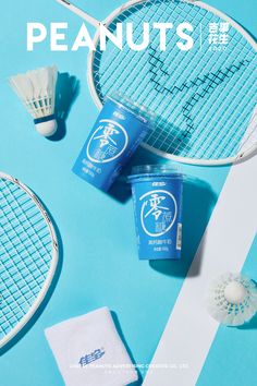 two tennis racquets sitting next to each other on top of a blue surface