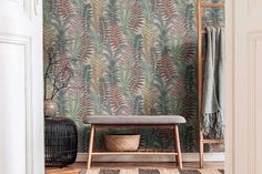 a bench in front of a wallpapered room with plants and leaves on it