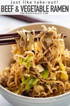 a white bowl filled with beef and vegetable ramen next to chopsticks in it