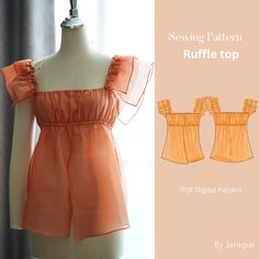 an orange top with ruffles is shown on a mannequin