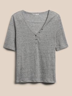 Equally suited to the weekly grind or weekend brunch, this casual linen henley is crafted from linen that stays cool and fresh in luxurious style.  SEMI-FITTED: Cut for a not-too-tight, not-too-loose fit.  V-neck with button placket.  Straight hem. Summer Cotton Henley With Buttons, Summer Everyday Henley With Button Closure, Summer Henley With Button Closure, Summer Henley With Buttons, Spring Casual Henley With Button Closure, Casual Spring Henley For Everyday Wear, Linen Tops With Buttons For Casual Gatherings, Spring Relaxed Fit Henley For Everyday, Henley Neckline Tops For Spring Everyday Wear