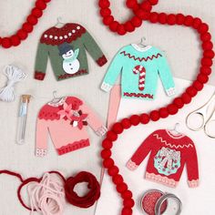 an assortment of sweaters and other items are displayed on a table with red beads