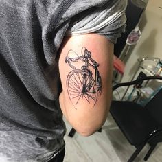 a man with a bicycle tattoo on his arm