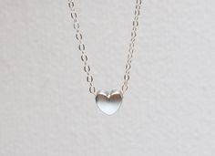 This necklace features:  16,5 inch sterling silver delicate chain  tiny silver toned heart measures 5mm.
You can have it also in 14kt gold filled for same price. I can adjust necklace length to your demands, also add me a note if you wish a different necklace length at the checkout. Options 14'',16'', 17'', 20''.
CLICK HERE for 14k SOLID gold heart necklace: 182969005/gold-heart-necklace-tiny-14k-gold-heart?
? I offer free shipping worldwide.
I ship from Europe by priority airmail.
Thanks! ?, Ma Tiny Heart Necklace, Gold Heart Necklace, Everyday Necklace, Silver Heart Necklace, Delicate Chain, Tiny Heart, Gifts For My Sister, Necklace Sterling Silver, Heart Of Gold