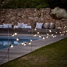 some lights that are next to a pool