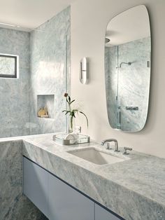 a bathroom with two sinks and a large mirror over it's sink area,