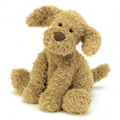 a brown stuffed dog sitting up against a white background