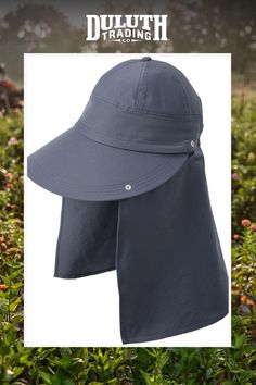 a blue hat with the words, dullth trading on it in front of some bushes