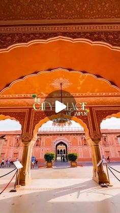 the entrance to an orange and pink building