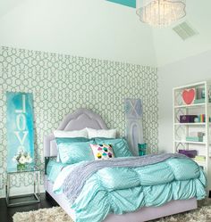 a bedroom decorated in pastel blue and white with lots of shelving on the wall