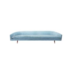 a blue couch sitting on top of a white floor