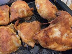 several pieces of chicken sitting on top of a grill