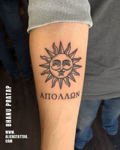 a tattoo on the arm of a man with an sun and moon above his head