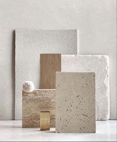 several different types of tile on display in front of a white wall with a gold ring