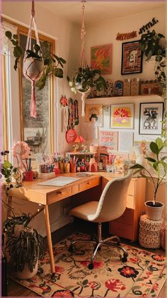 a home office with plants hanging from the ceiling and a desk in front of a window