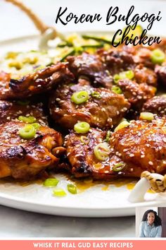 a white plate topped with meat covered in sauce and green onions next to a woman