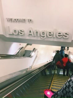 people on an escalator at the los angeles airport