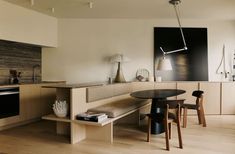 a kitchen area with a table, stove and oven