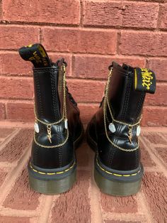 Lunar Lotus Boot Chains are the perfect way to spice up your Doc Martens or Combat Boots!  The chain length fits both Platform and Classic heel heights - Each order comes with a set of two chains of the same style - Each set is handmade. This Set Includes: - 4 Resin & Gold Cloud Charms (2 each side) - 2 Gold Lightning Bolt Charms (1 each side) - Clips: 14mm 18k Gold Plated - Chain: 549cm Imitation 12k Gold - Fittings: 6mm 18k Gold Plated Application: Lace and tie your boots as normal. Next, open Chain With Charms, Gold Lightning, Boot Chains, Wrap Boots, Taylor Swift Concert, Classic Heels, Star Gift, Shoe Clips, Lightning Bolt