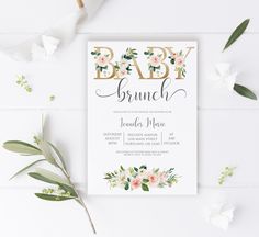 a baby brunch is shown with flowers and greenery