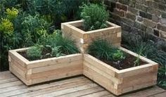 three wooden planters sitting on top of a wooden deck