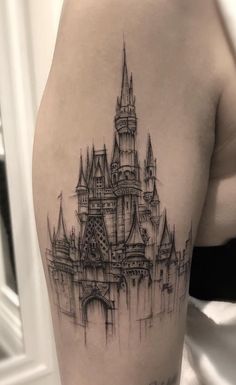 a black and white photo of a castle tattoo