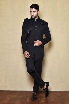 Black full sleeves bandhgala crafted in italian fabric with metallic moulded swerve embellishment and cross cut hem. - Aza Fashions Formal Traditional Wear With Traditional Drape For Party, Formal Party Wear Kurta With Traditional Drape, Formal Party Wear Sherwani With Traditional Drape, Designer Fitted Sherwani For Ceremonial Occasions, Fitted Black Bollywood Bandhgala, Designer Fitted Ceremonial Traditional Wear, Formal Bollywood Fitted Kurta, Fitted Party Wear Kurta For Formal Occasions, Fitted Kurta For Formal Party Wear