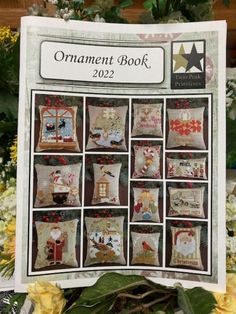 an ornament book with pictures of santa and other christmas items on it, surrounded by flowers