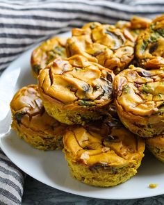 a white plate topped with muffins on top of a table