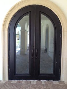 an arched double door with glass on the outside