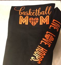 there is a black t - shirt with the words basketball mom and an orange heart on it