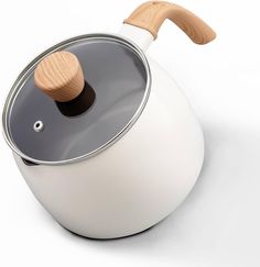 a white tea pot with a wooden lid