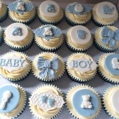 baby shower cupcakes with blue and white frosting on top are displayed in a box